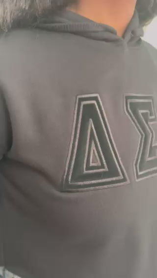 Delta Sigma Theta black-on-black cropped hoodie with embroidered Greek letters front view
