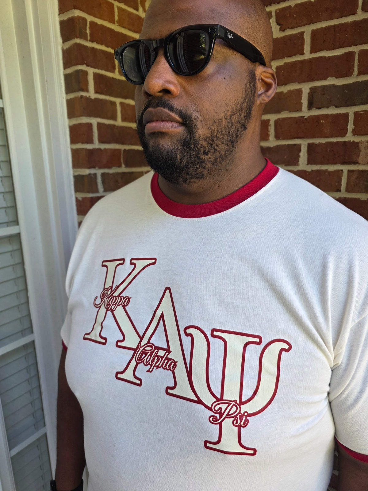 Close-up view of Kappa Alpha Psi letters on cream cotton ringer tee shirt