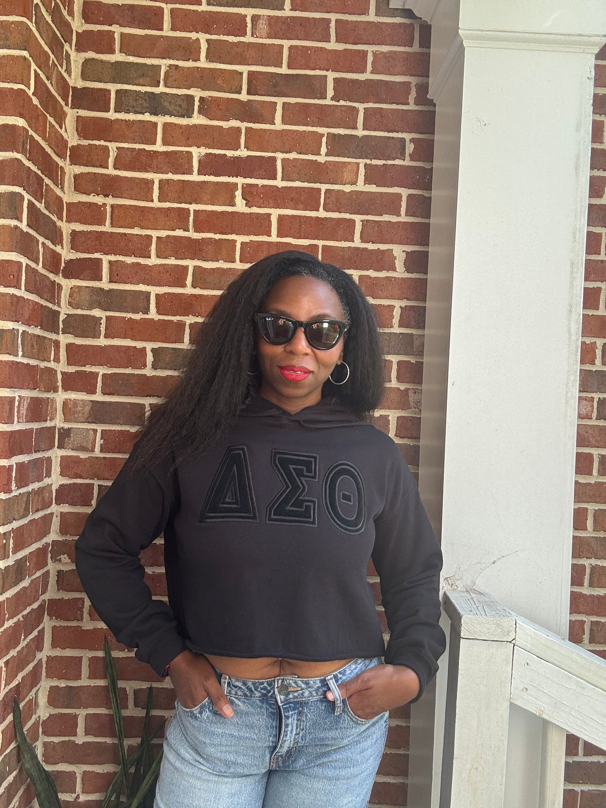 Delta Sigma Theta black-on-black cropped hoodie with embroidered Greek letters front view
