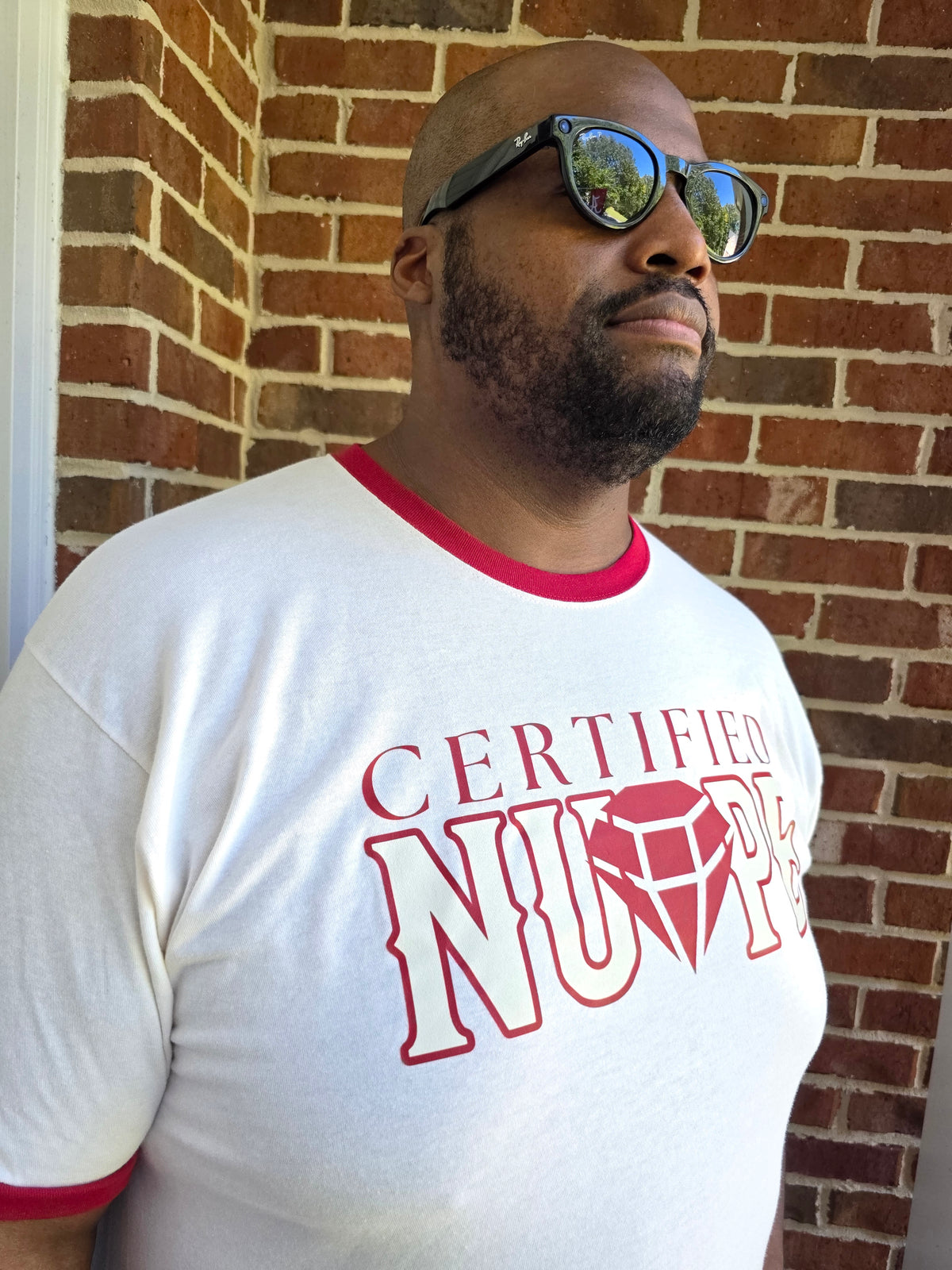 Close-up of Certified Nupe graphic print on cream cotton ringer tee shirt