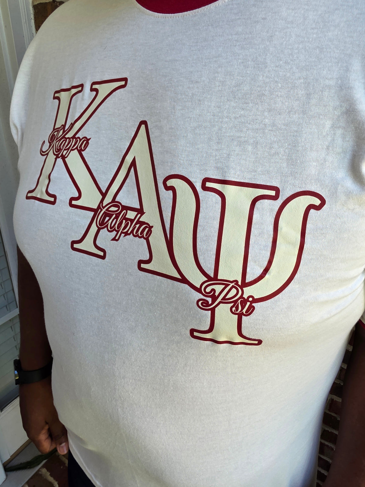 Model wearing vintage style Kappa Alpha Psi cream and crimson ringer tee