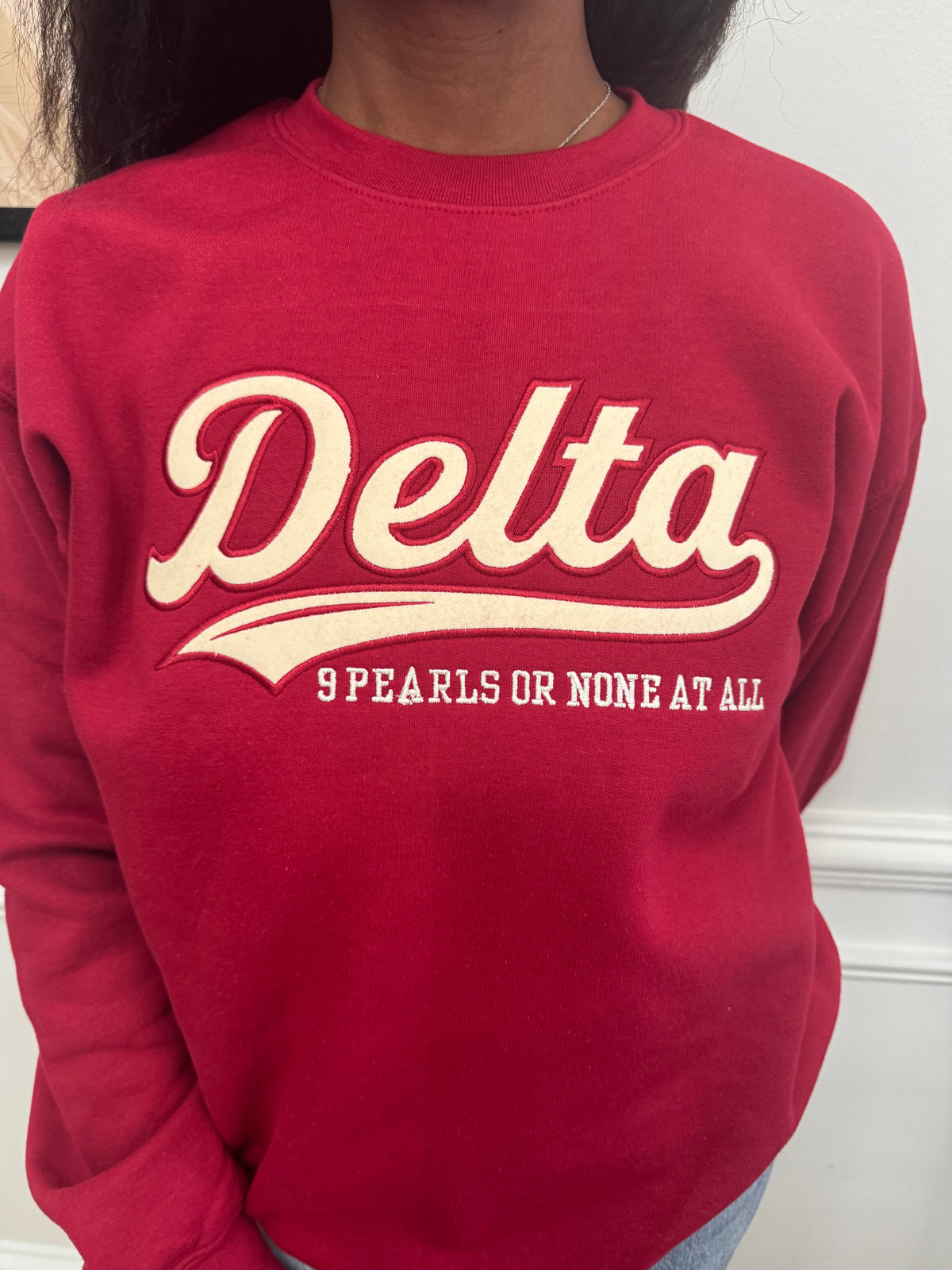 Delta Sigma Theta 9 Pearls or None at All crimson embroidered crewneck sweatshirt front view